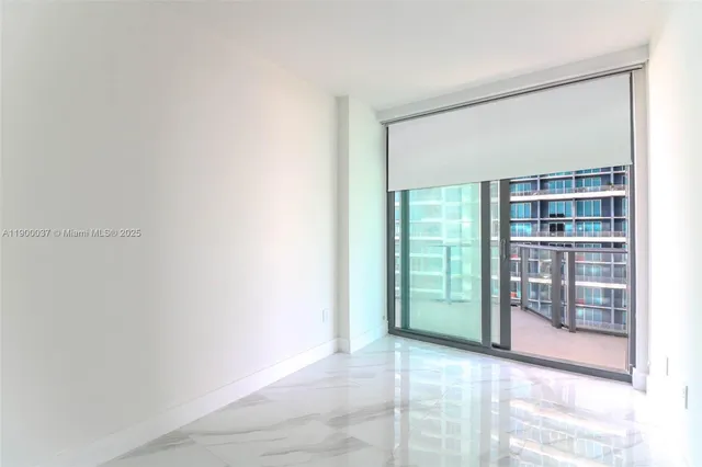 a view of an empty room with glass door