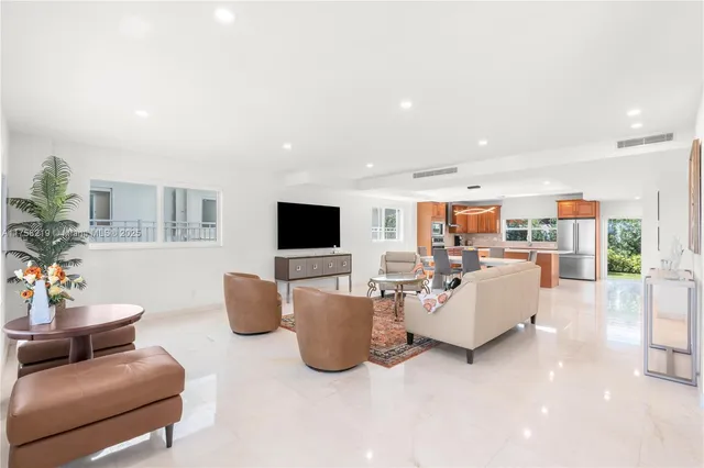 a living room with furniture potted plant and a window