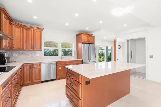 a kitchen with stainless steel appliances granite countertop a sink stove and refrigerator