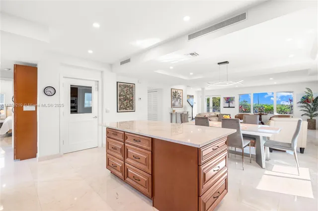 a bathroom with a granite countertop sink a toilet and shower
