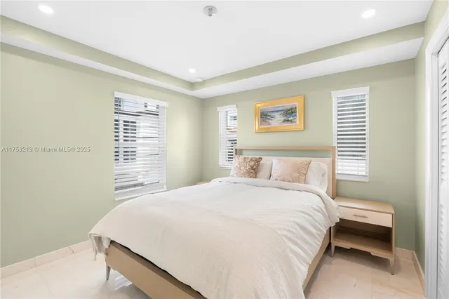 a bedroom with a large bed and a large window