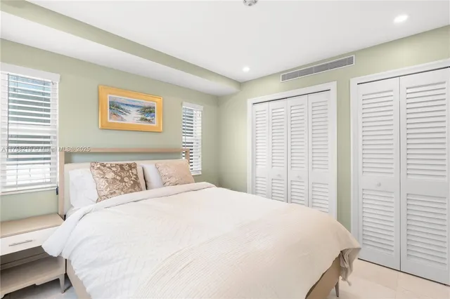 a spacious bedroom with a bed and a view of bathroom