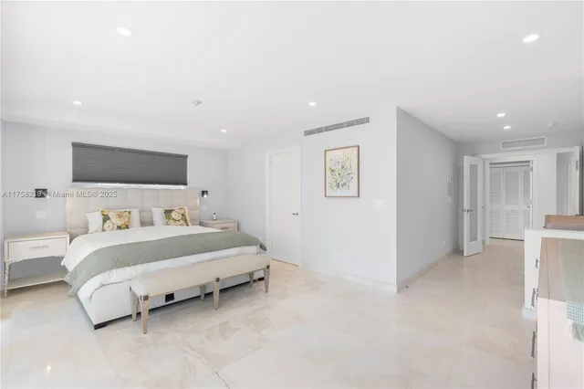 a bathroom with a granite countertop sink a large mirror and a bathtub