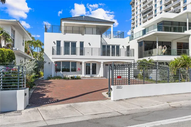 a front view of a building with a garden