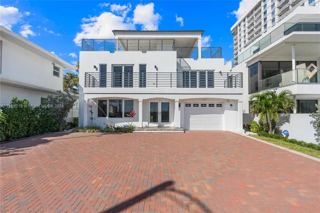 a front view of a house with yard and green space