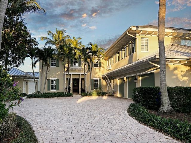 a open kitchen with stainless steel appliances kitchen island granite countertop a table and chairs in it
