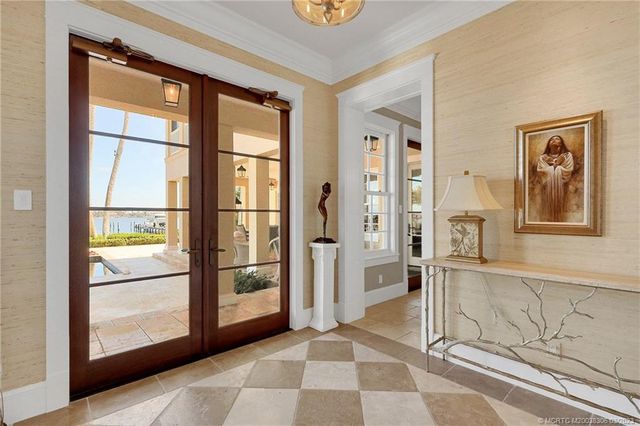 a kitchen with granite countertop a stove and white cabinets