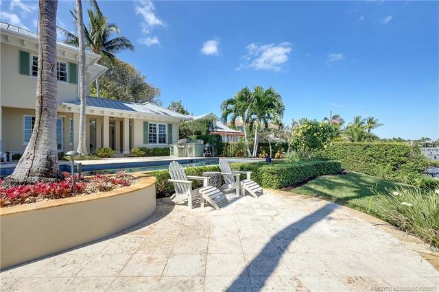 a bedroom with a bed a couch and chandelier