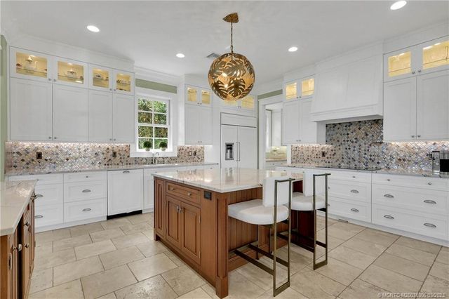 a dining room with furniture a chandelier and a rug