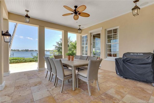 an aerial view of a house with a yard and potted plants