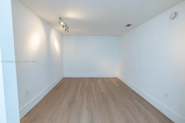 a dining room with furniture a chandelier and wooden floor