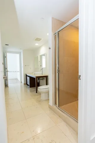 a bathroom with a glass shower door and a bathtub