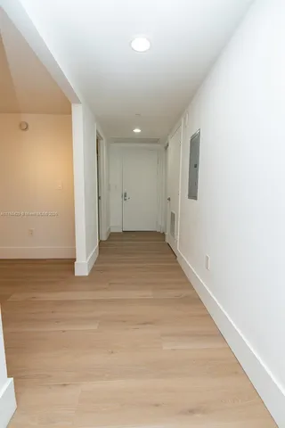 a view of a tall building sitting in the middle of a yard