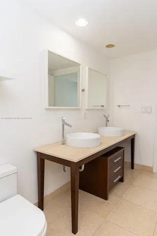 a dining room with furniture and a kitchen view
