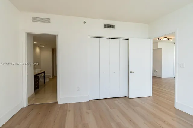 a living room with furniture a table and chair with wooden floor