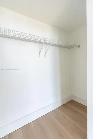 a living room with furniture a flat screen tv and a large window