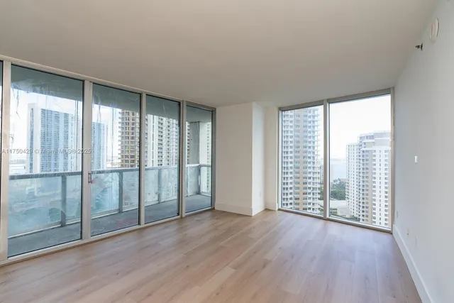a view of wooden floor and windows in a room