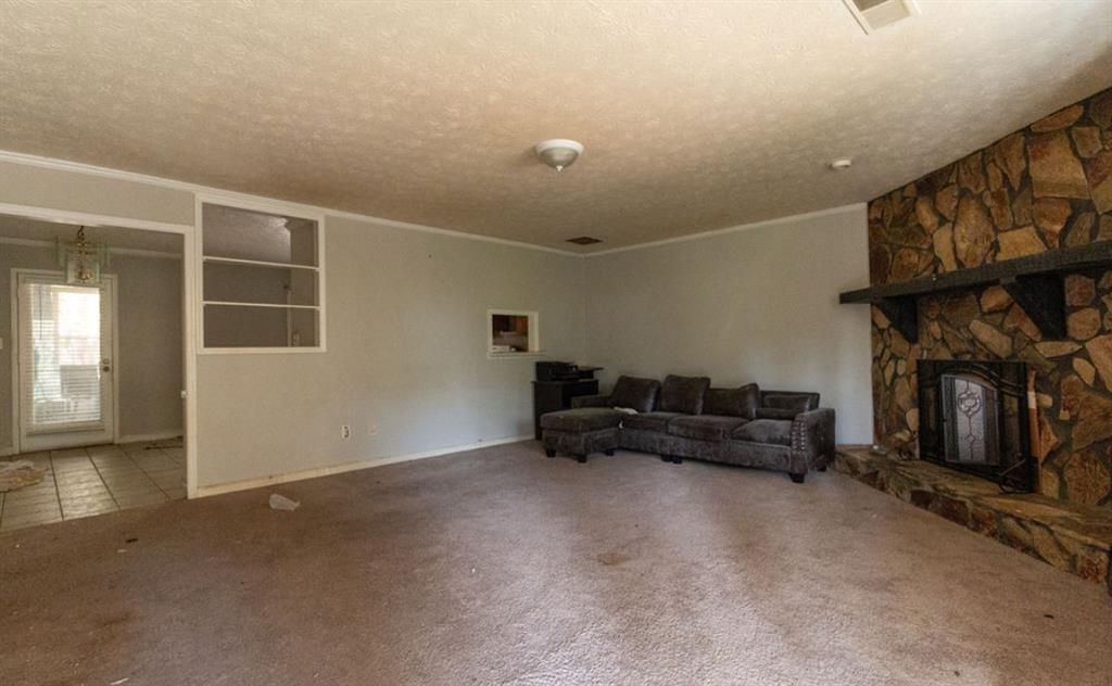 137 Springvalley Circle Stockbridge, GA 30281 - Photo 3 of 4 a living room with furniture and a fireplace