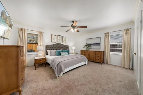 a spacious bedroom with a bed and a refrigerator