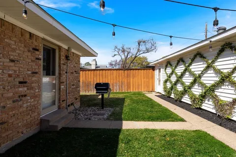 a view of yard with patio