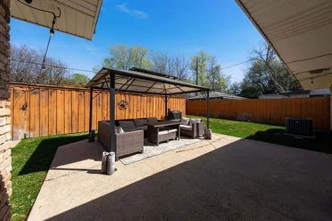 a view of backyard with patio