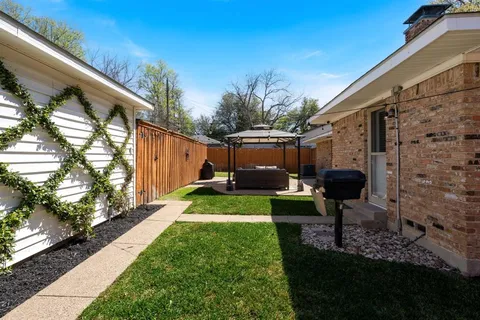 a view of yard with swimming pool outdoor seating and barbeque oven