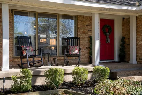 a front view of a house with a yard and porch