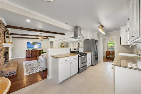 a large white kitchen with cabinets