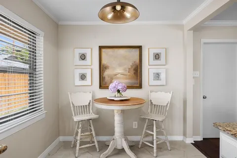 a dining room with furniture and window
