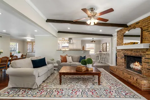 a living room with furniture fireplace and a table