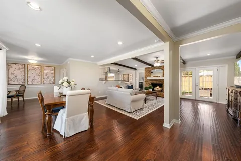 a living room with furniture dining table and wooden floor