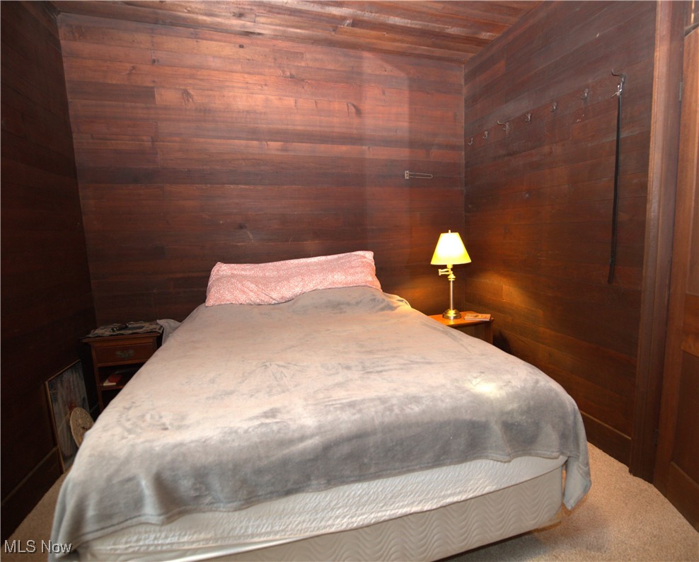 22760 Roy Croy Road Senecaville, OH 43780 - Photo 16 of 46 Carpeted main level bedroom with wooden walls and wood ceiling