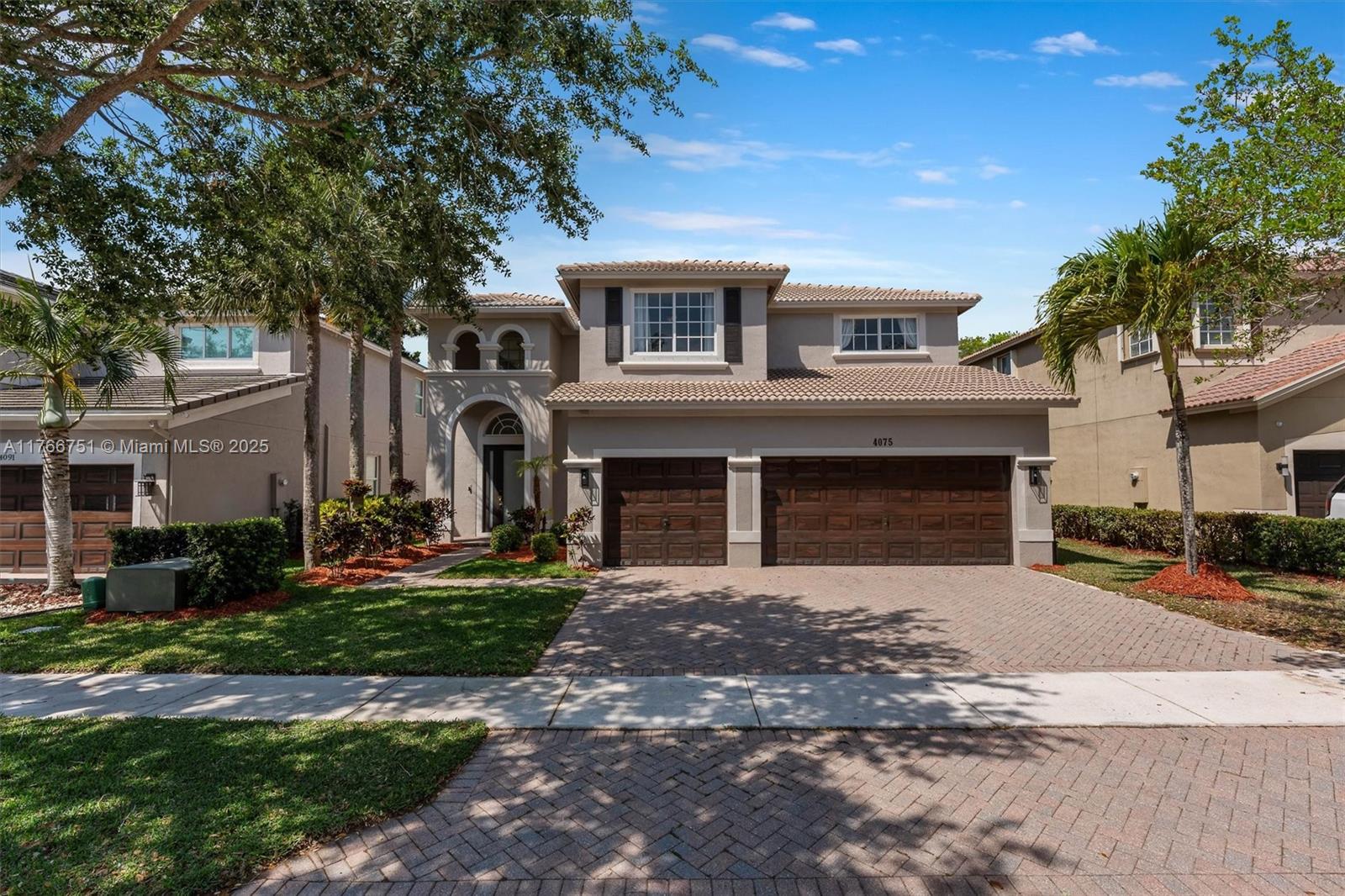 4075 Cascade Terrace Weston, FL 33332 - Photo 1 of 1 a front view of a house with a yard