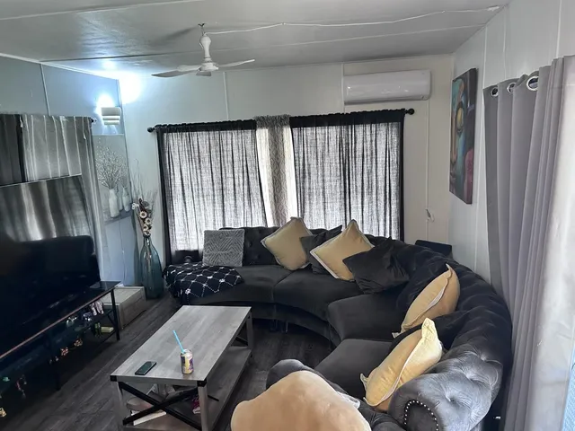 a living room with furniture and a flat screen tv