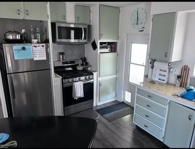 a kitchen with stainless steel appliances a refrigerator stove and sink
