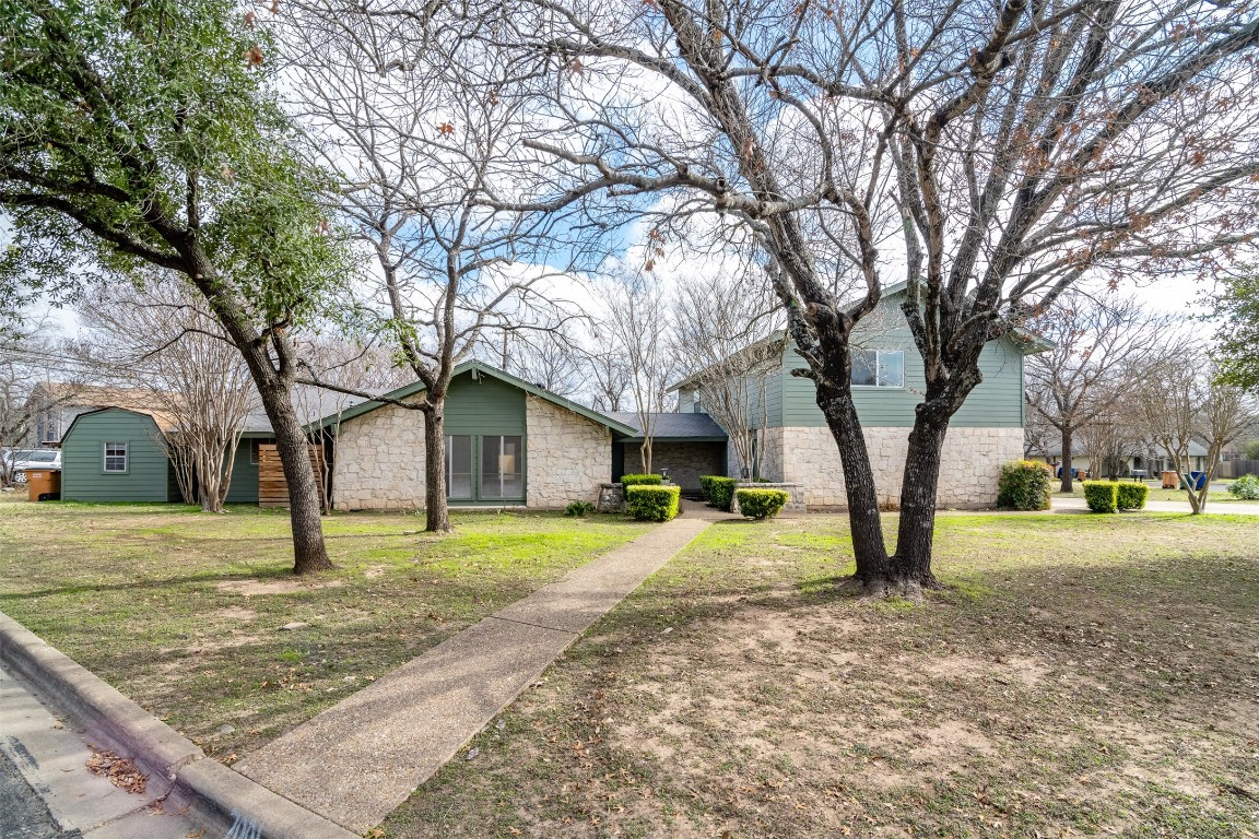 7001 Whispering Creek Drive, Unit B Austin, TX 78736 - Photo 1 of 1 a view of a yard with a house and a trees