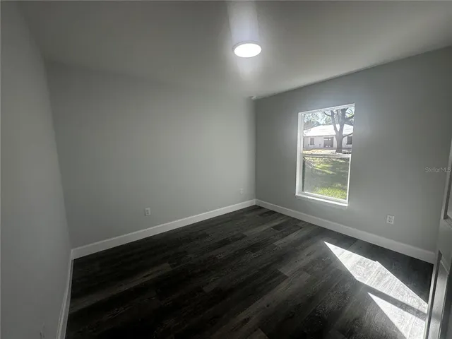 a view of room with hardwood floor and window