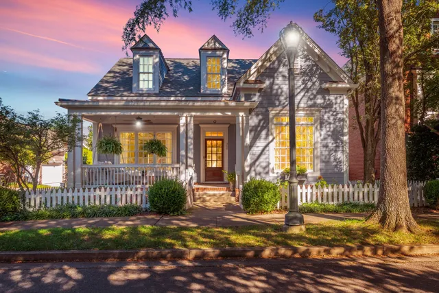 a view of a house with a small yard and plants