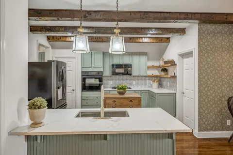 a en suite bathroom with a sink a mirror and shower