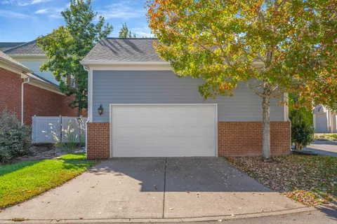a view of a house with backyard sitting area and garden