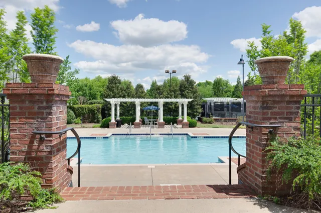 a view of a house with swimming pool and sitting area