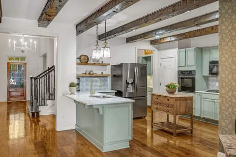 a kitchen with stainless steel appliances a refrigerator a stove a sink and a microwave