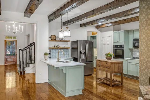 a kitchen with stainless steel appliances a refrigerator a stove a sink and a microwave