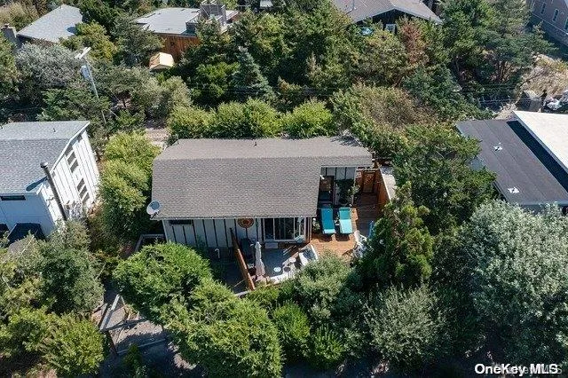 an aerial view of a house with yard and outdoor seating