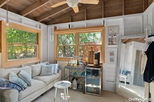 a living room with furniture and a floor to ceiling window
