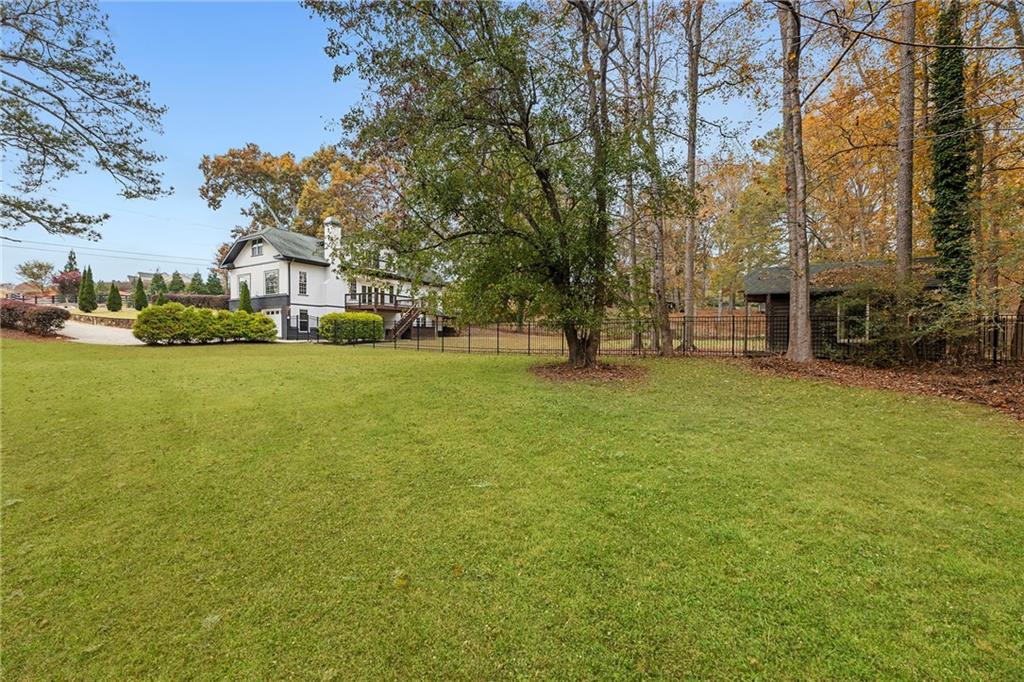 14440 Cogburn Road Alpharetta, GA 30004 - Photo 49 of 62 a view of a yard with a house in the background