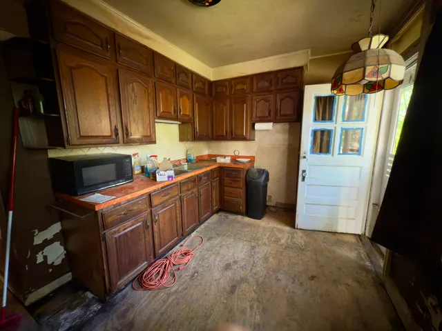 a kitchen with a refrigerator and a sink