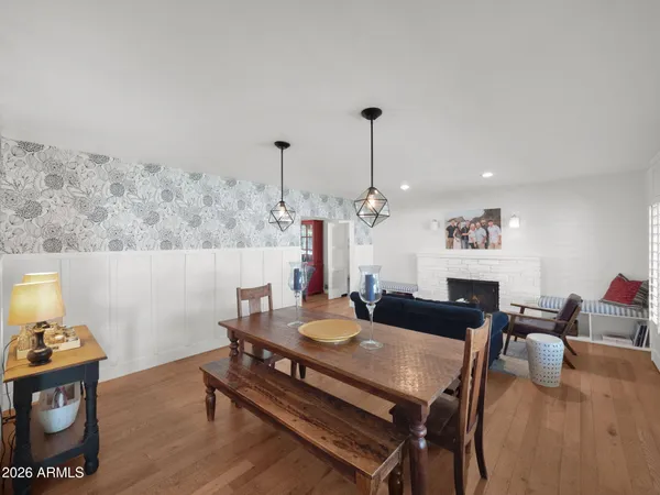 a living room with furniture kitchen view and a large window