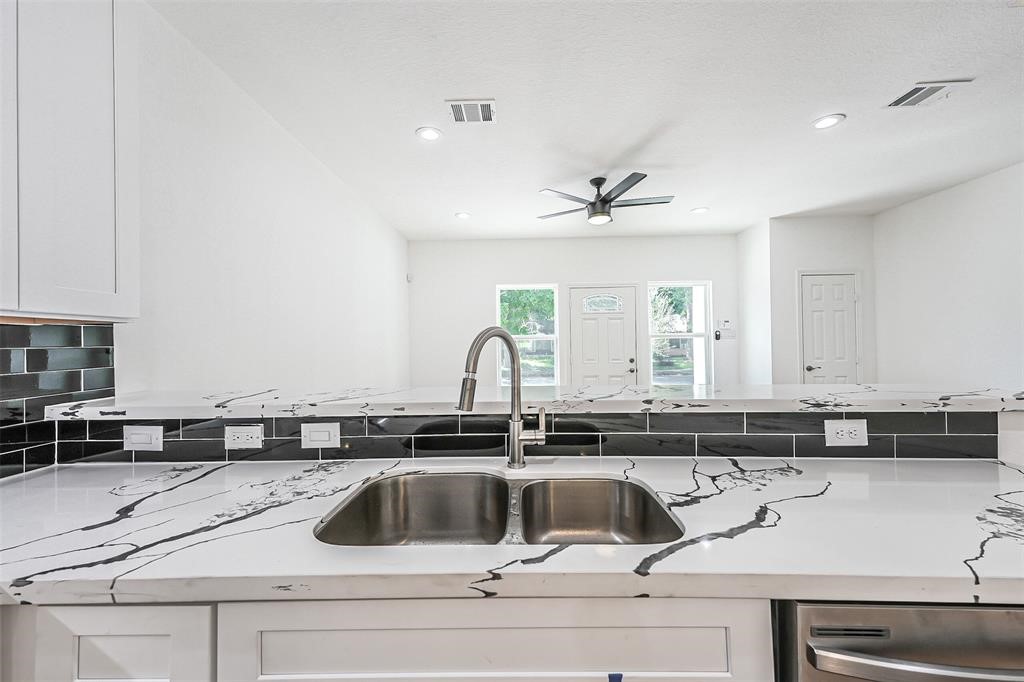 5317 Chennault Road, Unit A Houston, TX 77033 - Photo 4 of 11 a kitchen with a sink and cabinets