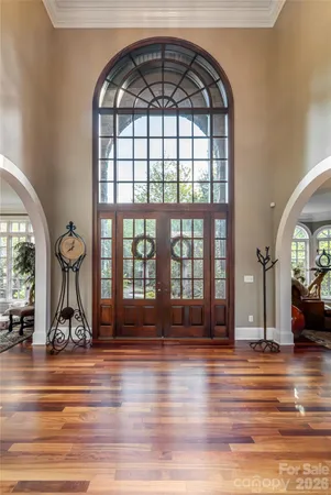 a living room with furniture a fireplace and a large window